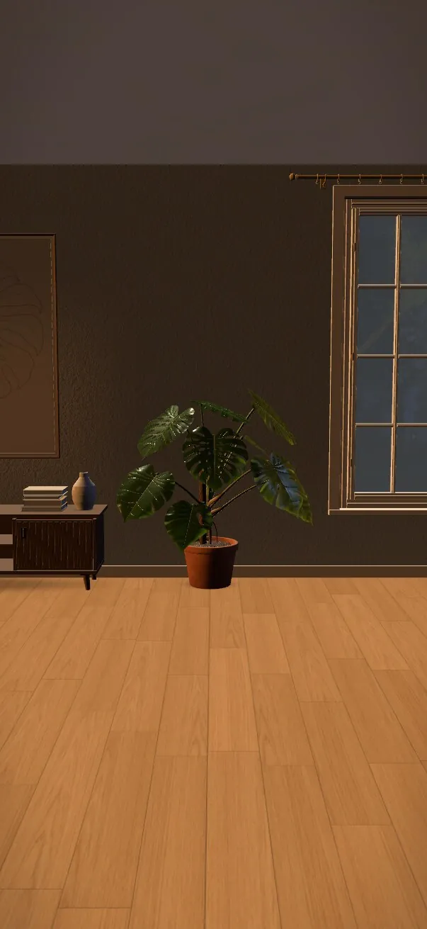 The same room at night, the Monstera lit by lamplight